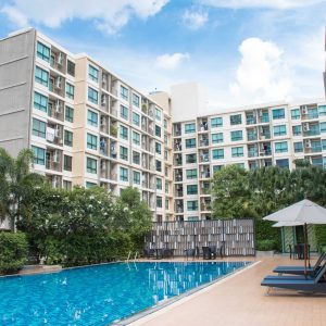 8-storey residential condo building with a swimming pool in the middle of the building.